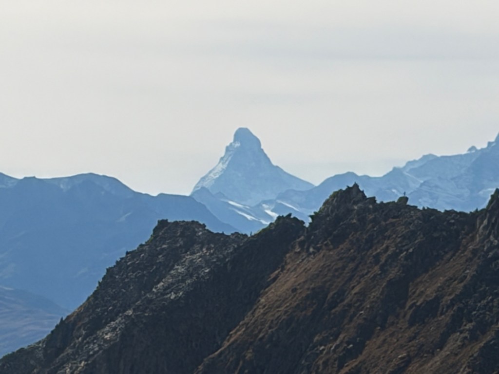 The Matterhorn rising in the distance above layered ridgelines.