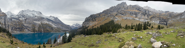 Wide lake and alpine meadow panorama