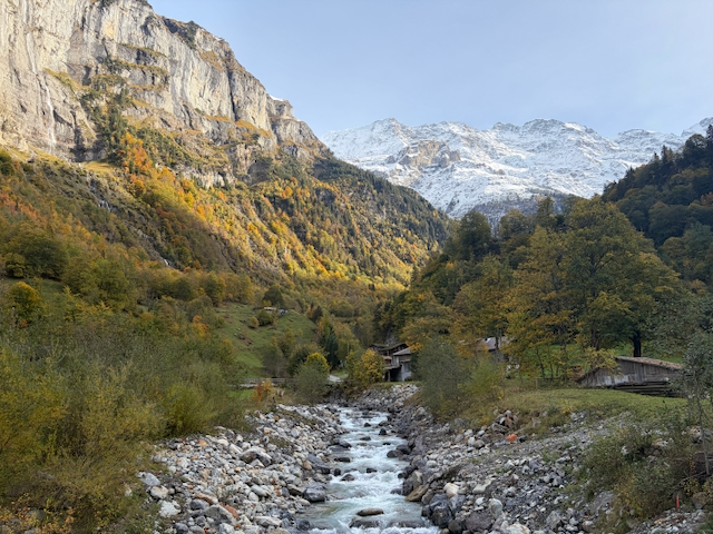 Rocky riverbed leading toward snowy mountains