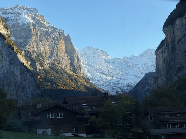 Village rooftops between dramatic valley walls