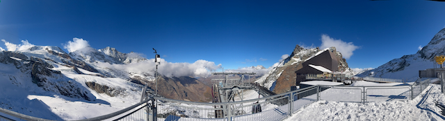 Wide snowy summit-station panorama