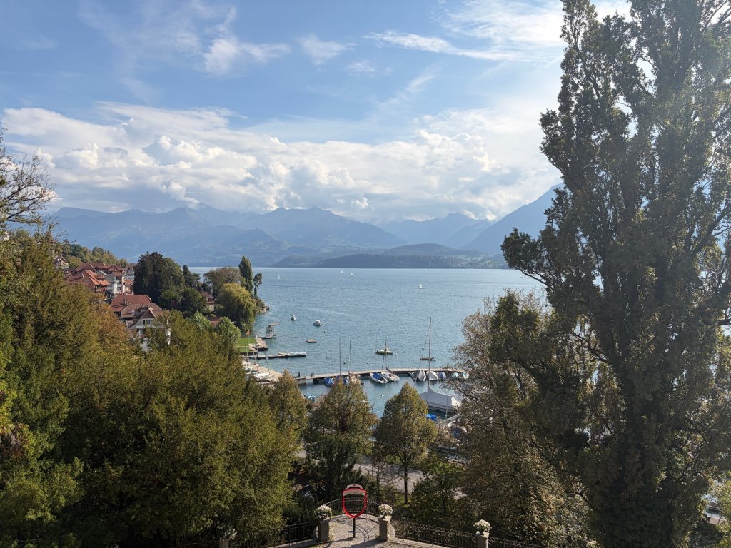 Sailboats on Lake Thun with mountains beyond the lake.