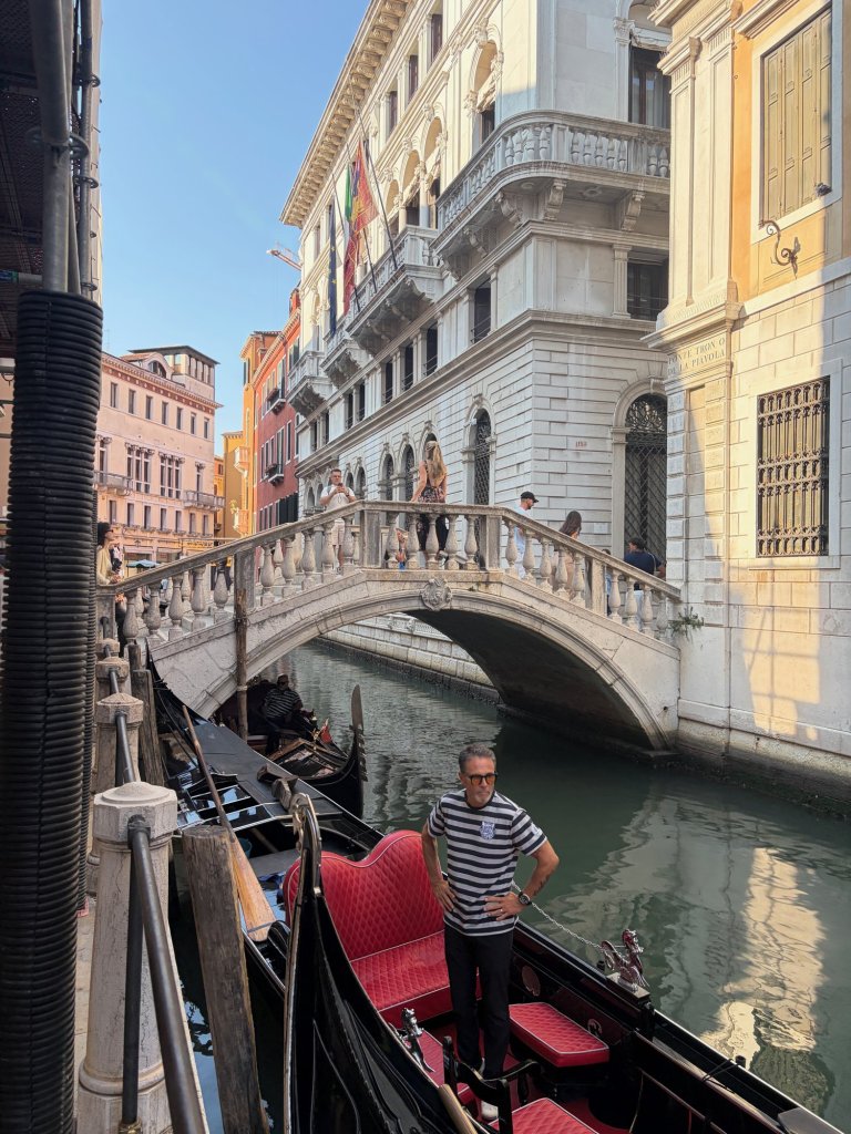 Gondolas beside a stone bridge