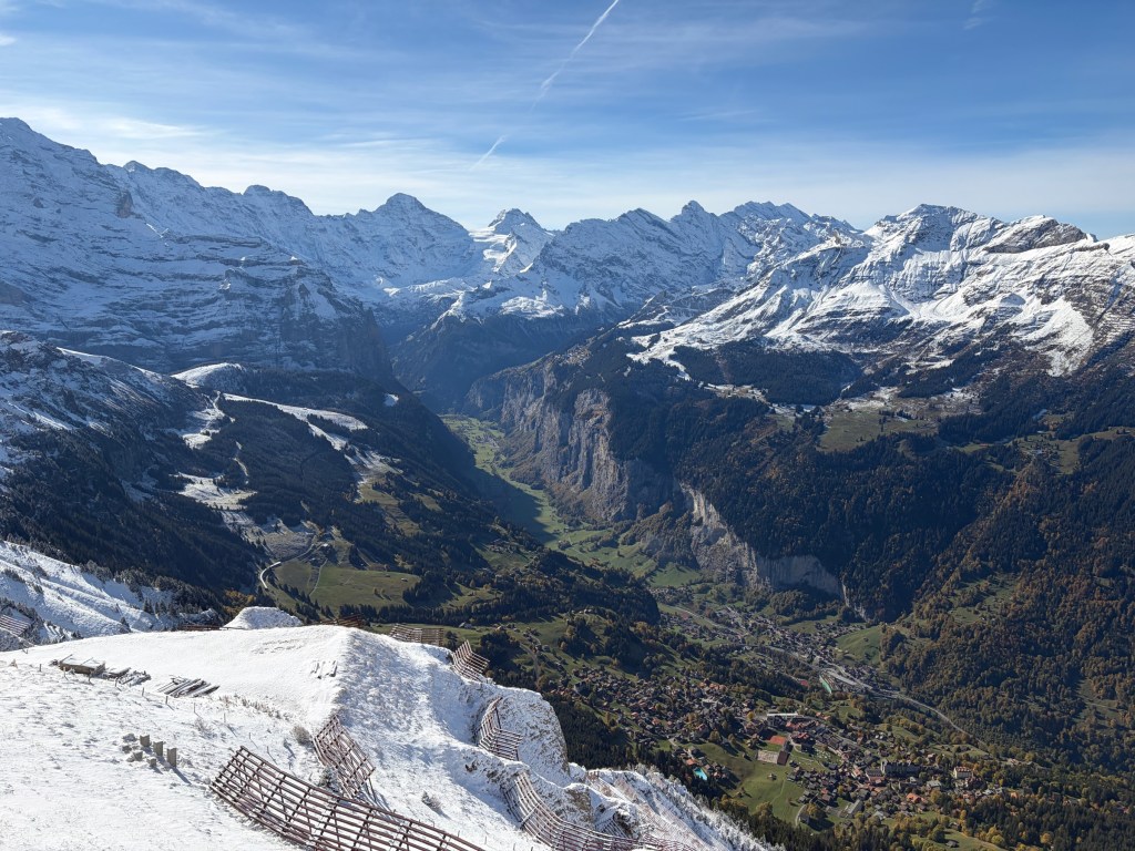 Snow-covered mountain peaks above the green Lauterbrunnen valley.
